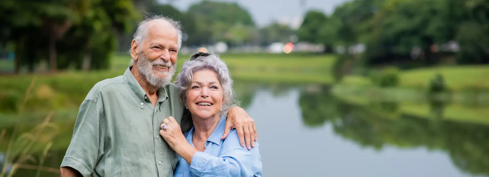 r-elderly-couple-hugging-and-smiling-in-park